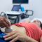 Woman getting ultrasound of a abdomen from doctor in hospital